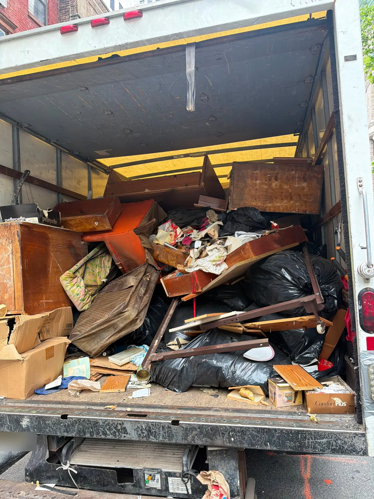 Drawers, furniture and bagged items from a hoarding cleanout loaded in the truck
